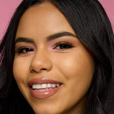 Modelo usando NYX Make 'Em Wonder™ Base de maquillaje en color 19 Warm Beige with soft glow and glossy neutral lips.